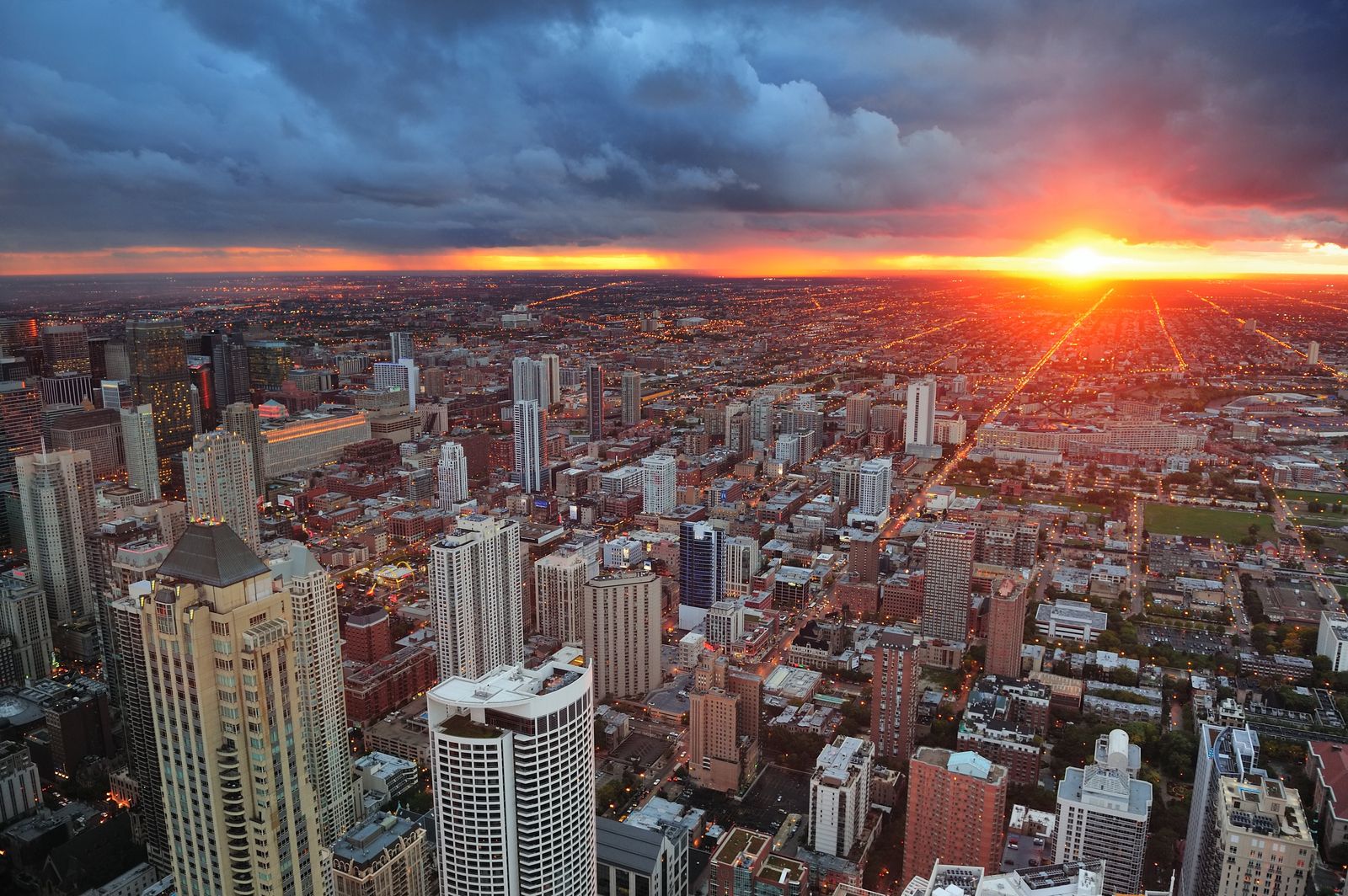Chicago at sunrise under a line of storm clouds, looking west over the neighborhoods
