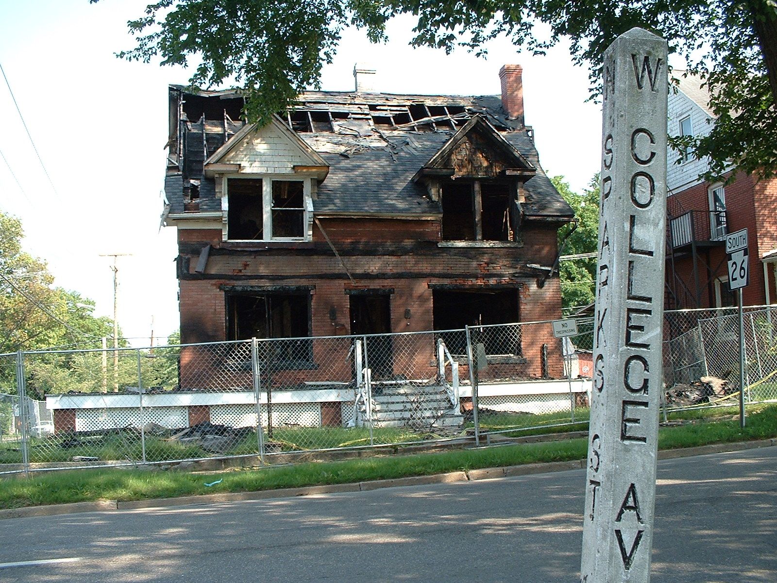 Two-story brick house with its roof and upper floor burned out after a fire